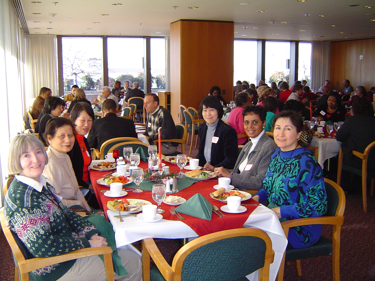 members seated at tables during holiday party