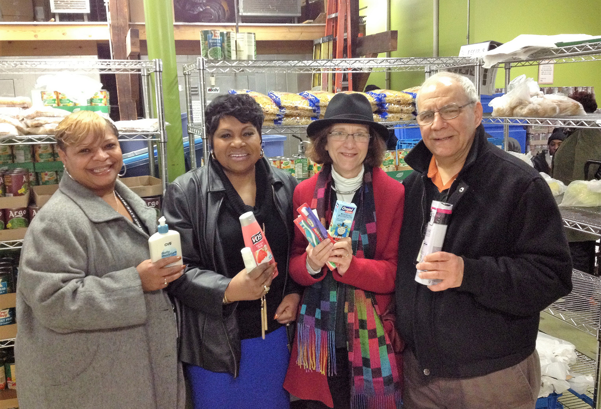 photo shows four union officers holding personal products for donation