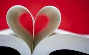 picture of an open book with pages curled into a heart shape